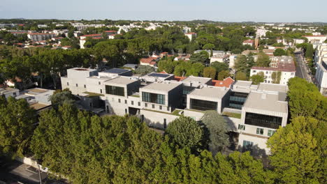 Modern-new-building-in-between-trees-aerial-France-sunny-day